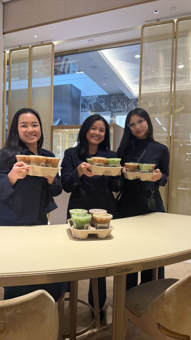 Guests carrying trays of Lakwatsa drinks at an event