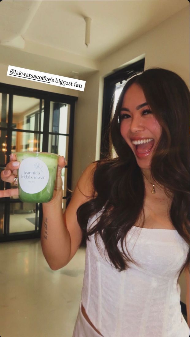 A guest holding a matcha with a custom event label